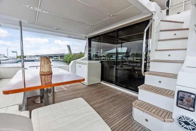 Class Dismissed Yacht Photos Pics 2017 Azimut 72 Flybridge yacht deck with seating, table, and stairs.