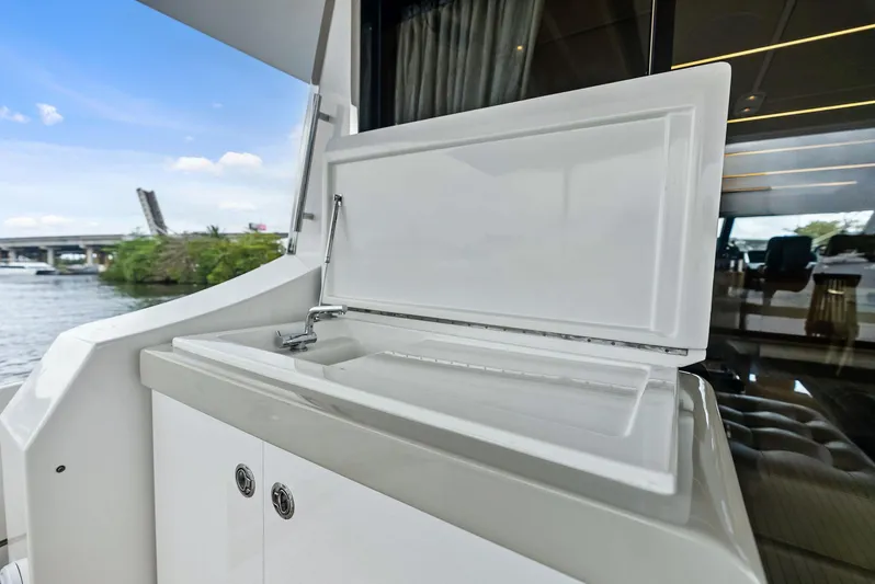 Class Dismissed Yacht Photos Pics Outdoor sink on 2017 Azimut 72 Flybridge yacht, with scenic waterway view.