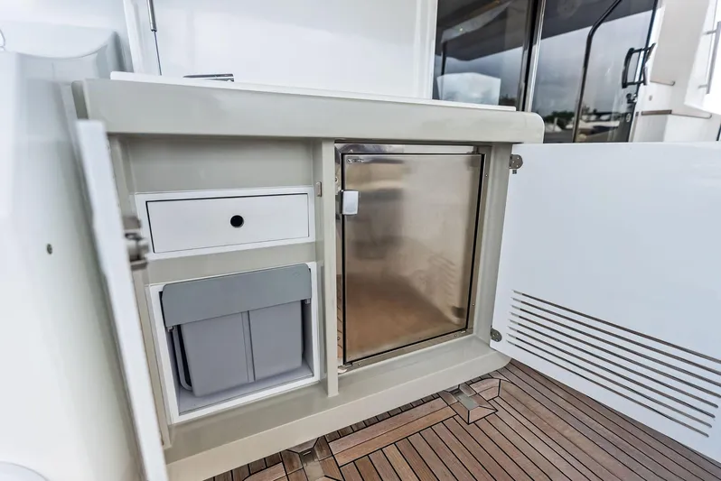 Class Dismissed Yacht Photos Pics 2017 Azimut 72 Flybridge yacht interior with storage and mini fridge.