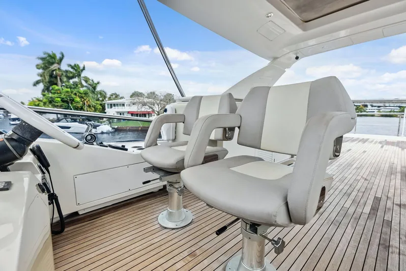 Class Dismissed Yacht Photos Pics Luxury seating on 2017 Azimut 72 Flybridge yacht, featuring sleek design and waterfront view.