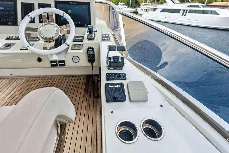 Class Dismissed Yacht Photos Pics Cockpit of 2017 Azimut 72 Flybridge yacht with modern controls and steering wheel.