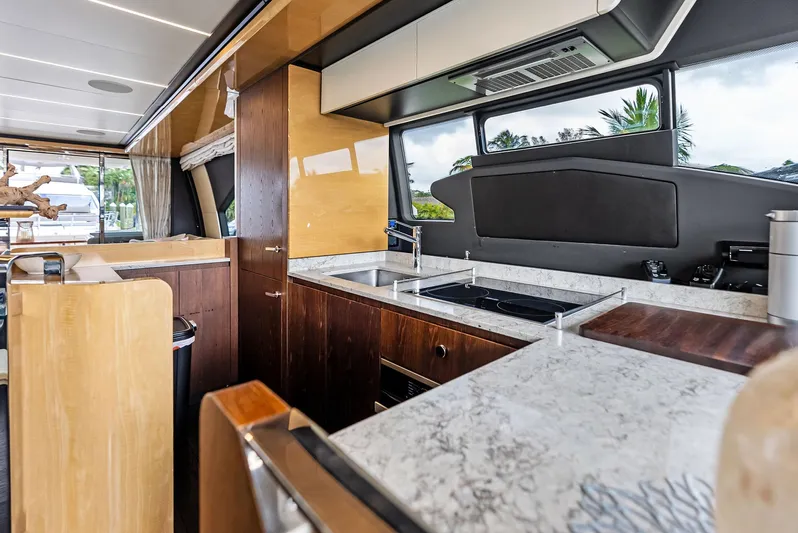 Class Dismissed Yacht Photos Pics Luxurious kitchen interior of 2017 Azimut 72 Flybridge yacht with modern amenities.