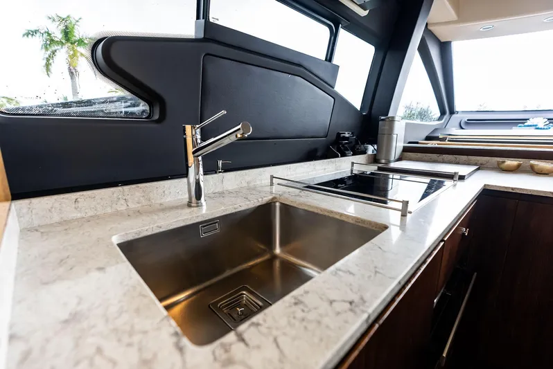 Class Dismissed Yacht Photos Pics Modern kitchen interior of 2017 Azimut 72 Flybridge yacht with sleek design.