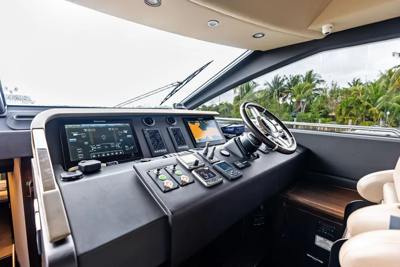 Class Dismissed Yacht Photos Pics 2017 Azimut 72 Flybridge helm with advanced navigation controls and tropical view.