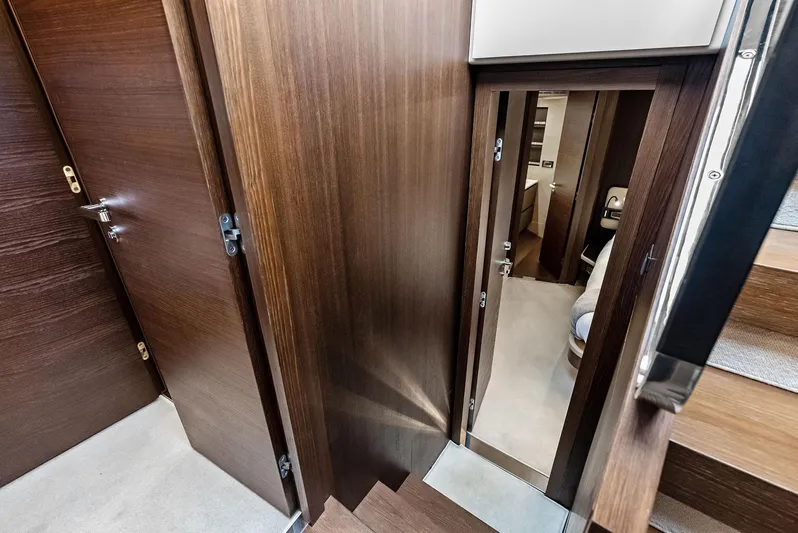 Class Dismissed Yacht Photos Pics Interior view of 2017 Azimut 72 Flybridge yacht with wooden doors and stairs.