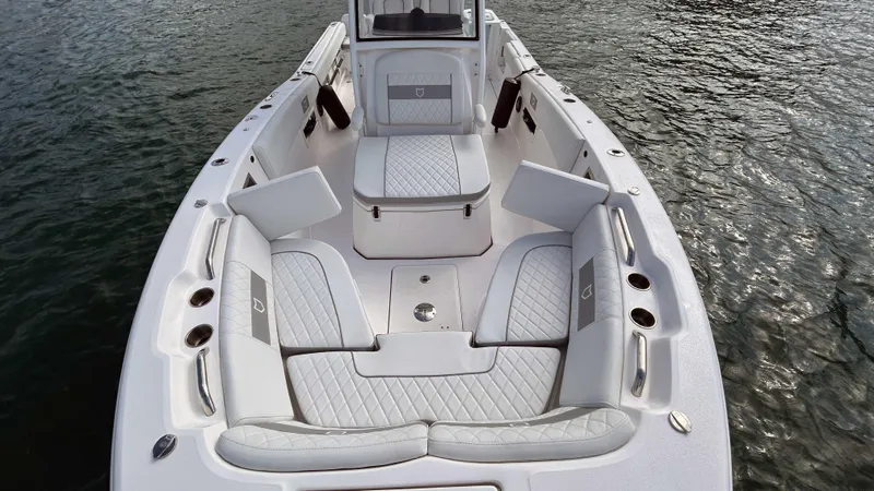  Yacht Photos Pics 2024 Sea Fox 268 Commander boat interior with cushioned seating on water.