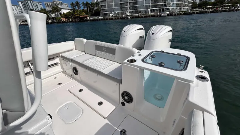  Yacht Photos Pics 2024 Sea Fox 268 Commander boat with dual engines and seating, docked by waterfront buildings.