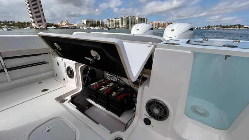  Yacht Photos Pics 2024 Sea Fox 268 Commander boat with open storage compartment, docked near waterfront buildings.