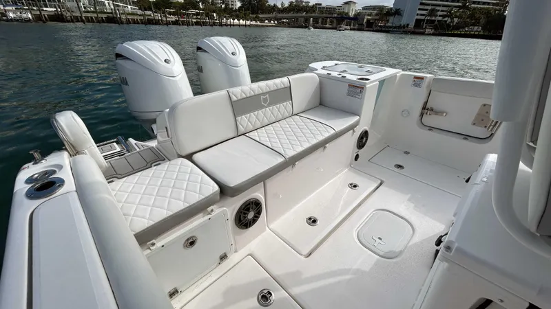  Yacht Photos Pics 2024 Sea Fox 268 Commander boat interior with cushioned seating and twin outboard motors.