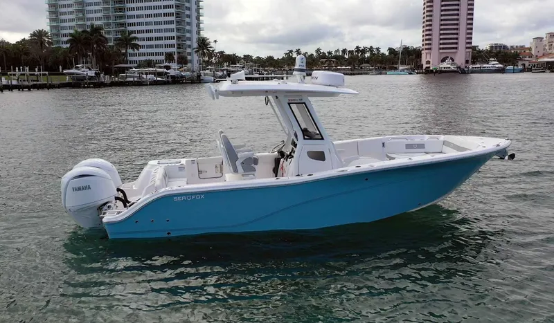  Yacht Photos Pics 2024 Sea Fox 268 Commander boat on water, cityscape background.