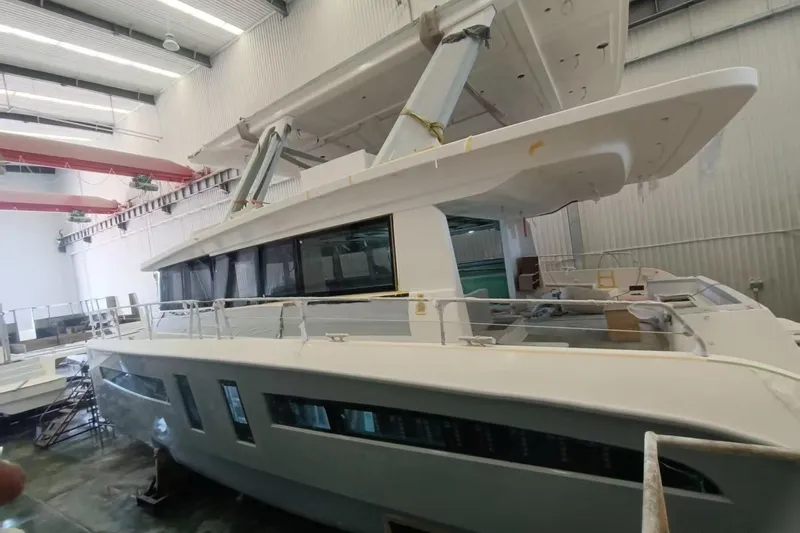 Mazarin Evo II - E-motion Italy - Parallel Hybrid Yacht Photos Pics 2025 Mazarin 55 EVO II E-Motion yacht in a shipyard, showcasing hybrid design.