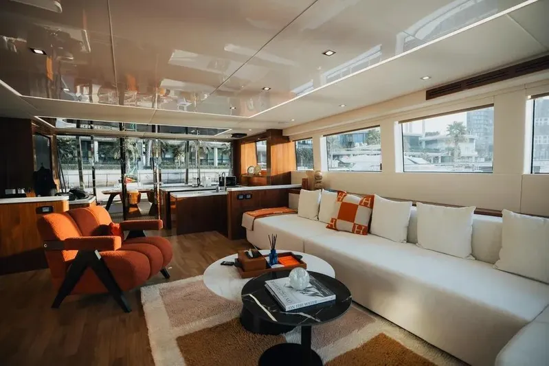 Mazarin Evo II - E-motion Italy - Parallel Hybrid Yacht Photos Pics Luxurious interior of 2025 Mazarin 55 EVO II yacht with modern furnishings and large windows.