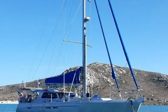 Gabsi Yacht Photos Pics Sailing yacht "Southwell 51" 2022 model on calm waters with rocky hills in the background.