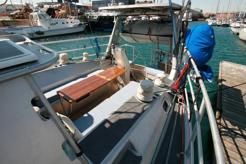 Gabsi Yacht Photos Pics Sailboat docked at marina, featuring a wooden bench and nautical equipment, Southwell 51, 2022.