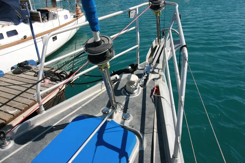 Gabsi Yacht Photos Pics Deck of 2022 Custom Southwell 51 yacht with railing and winch, docked by the water.