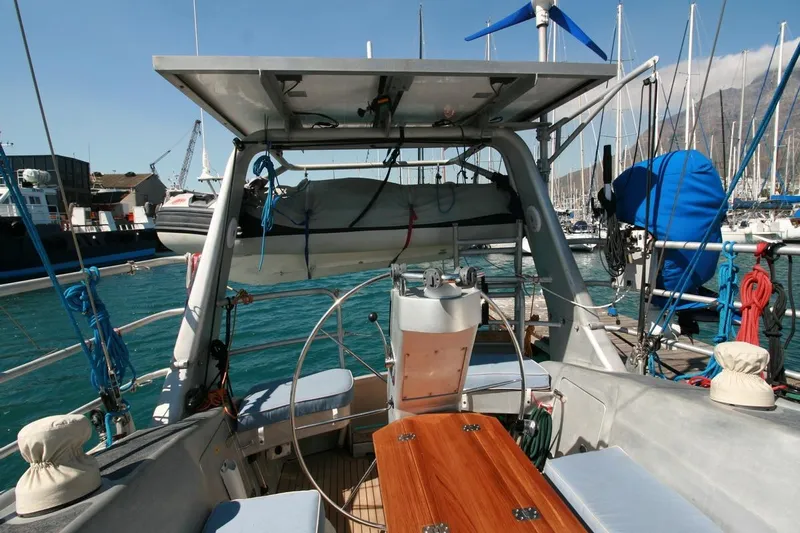 Gabsi Yacht Photos Pics Custom Southwell 51 sailboat deck with seating, steering wheel, and equipment, docked in marina.