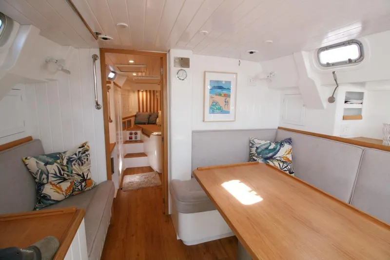 Gabsi Yacht Photos Pics Cozy interior of 2022 Custom Southwell 51 yacht with wooden table and seating area.