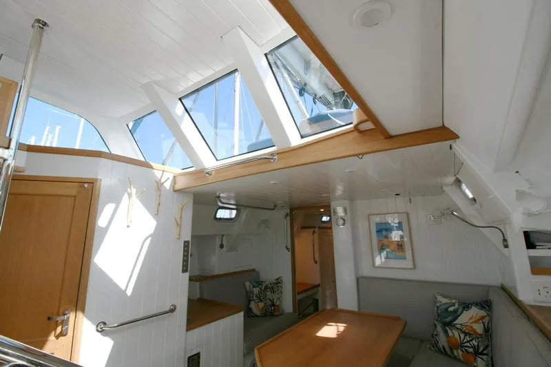 Gabsi Yacht Photos Pics Interior of 2022 Custom Southwell 51 yacht with skylights, wooden accents, and cozy seating area.