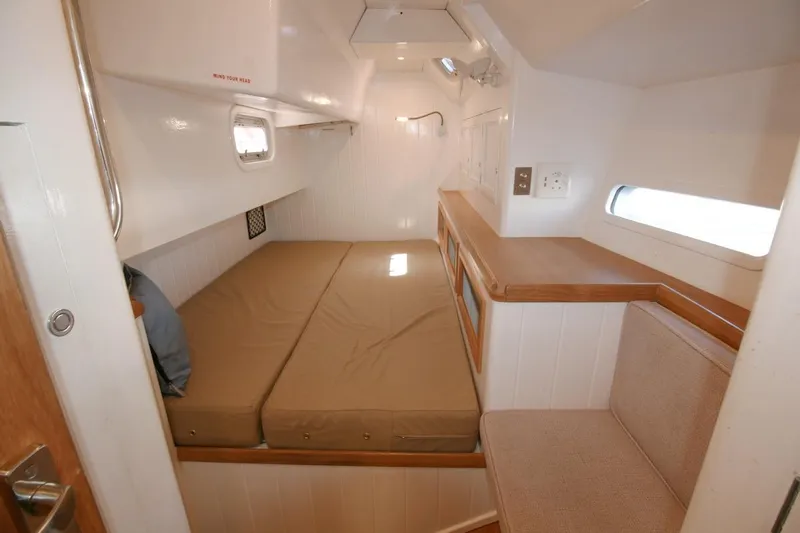 Gabsi Yacht Photos Pics Cozy cabin interior of 2022 Custom Southwell 51 yacht with bed and seating area.