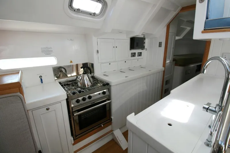 Gabsi Yacht Photos Pics Modern galley kitchen in 2022 Custom Southwell 51 yacht with stove and sink.
