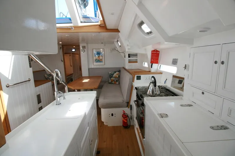 Gabsi Yacht Photos Pics Modern interior of 2022 Custom Southwell 51 yacht with kitchen and seating area.