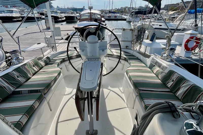 Sosy Yacht Photos Pics Cockpit of 2006 Beneteau Oceanis Clipper 423 yacht with striped cushions at marina.