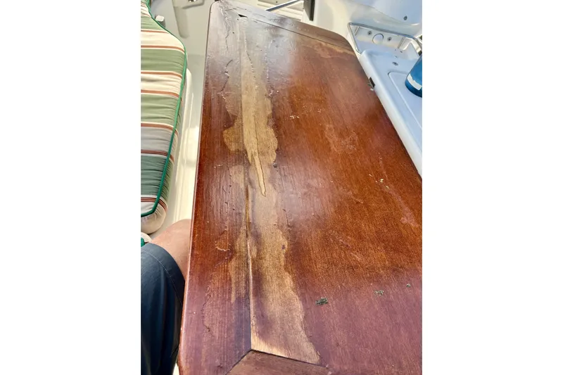 Sosy Yacht Photos Pics Worn wooden table on 2006 Beneteau Oceanis Clipper 423 yacht interior.