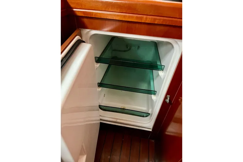 Sosy Yacht Photos Pics Open fridge with glass shelves inside a 2006 Beneteau Oceanis Clipper 423 yacht.