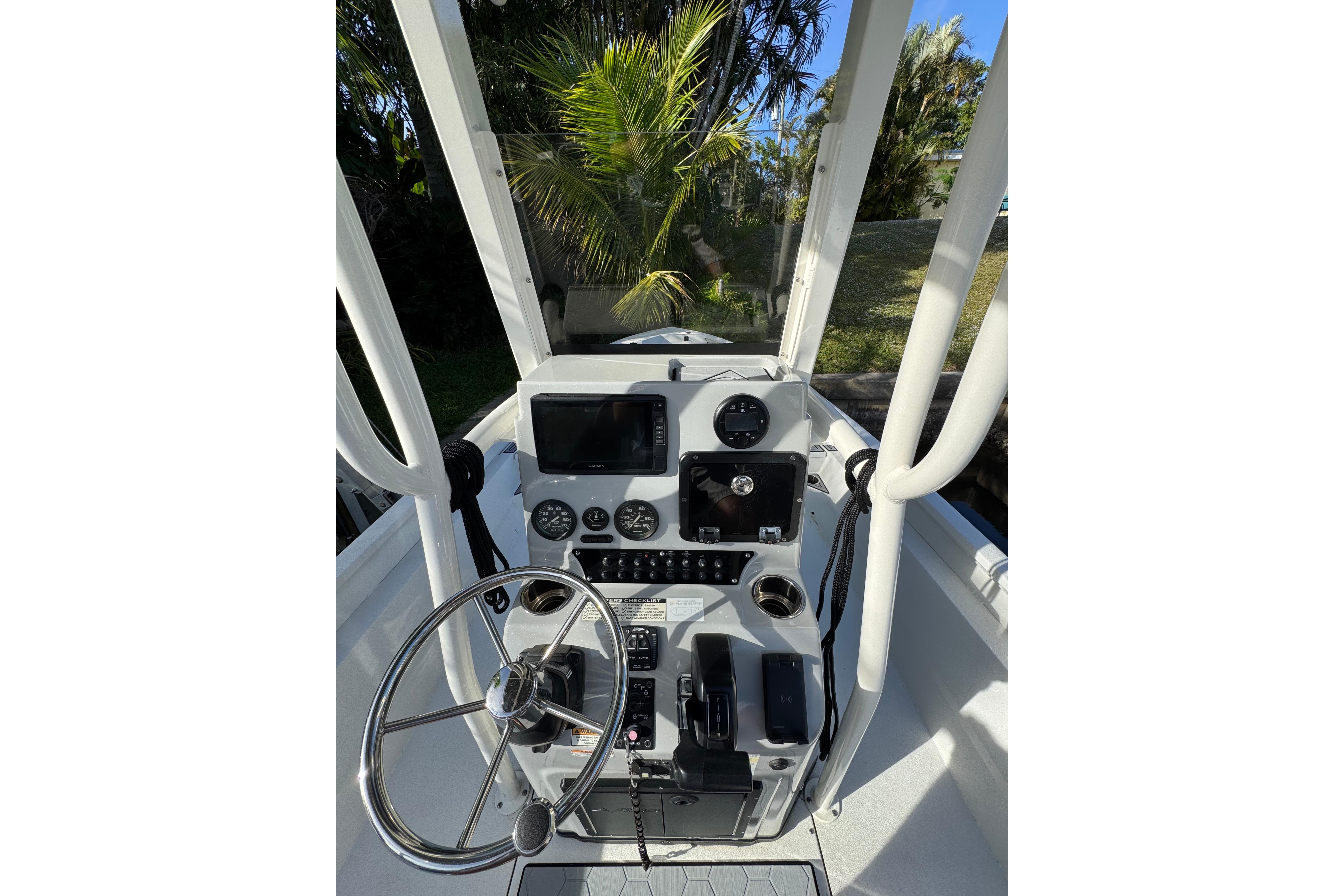 2022 Avid 23 FS Magnum boat console with steering wheel and navigation controls.
