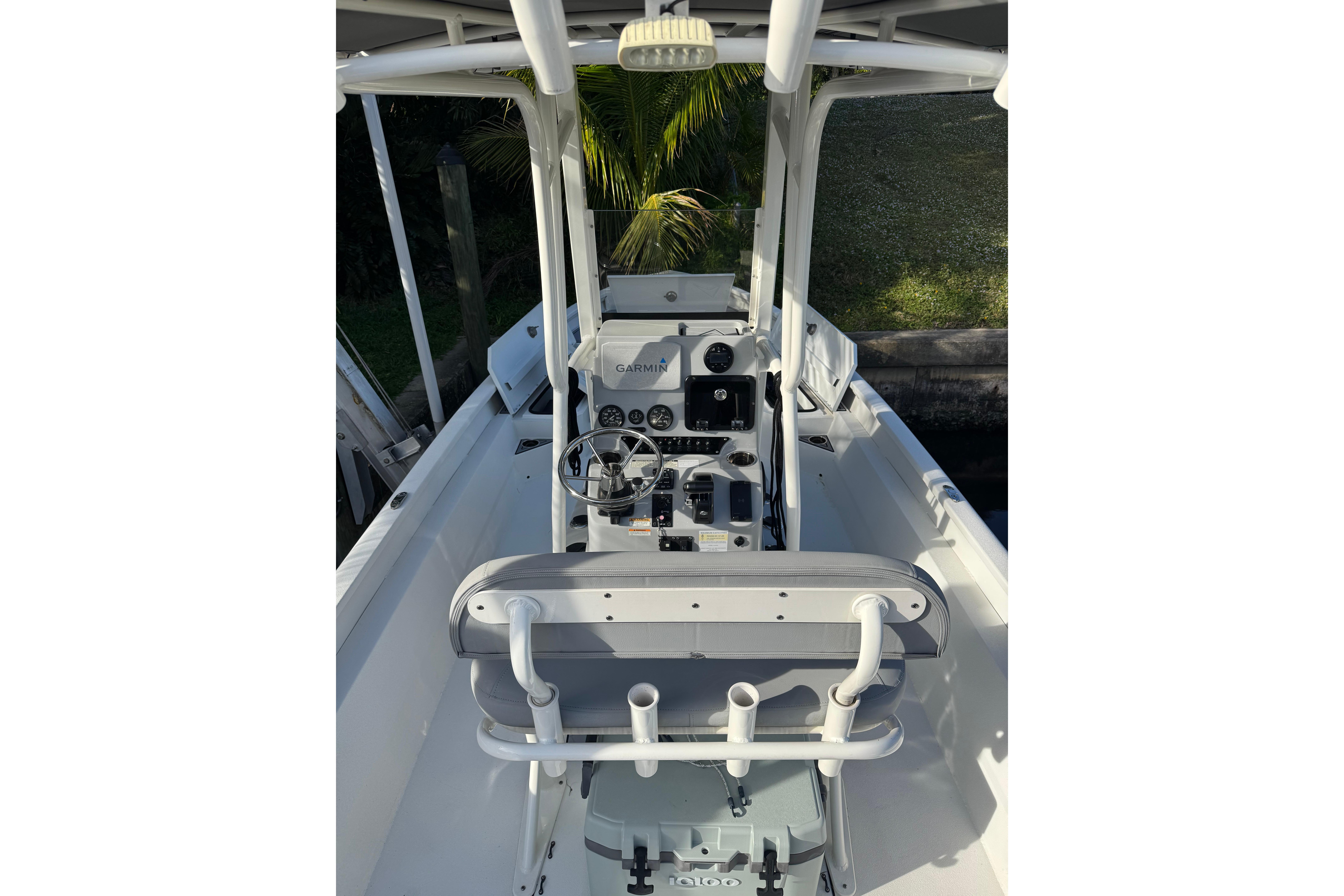 2022 Avid 23 FS Magnum boat interior with steering console and seating.