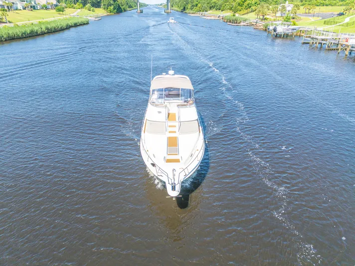  Yacht Photos Pics 1999 Sea Ray 450 Express Bridge cruising on a scenic river.