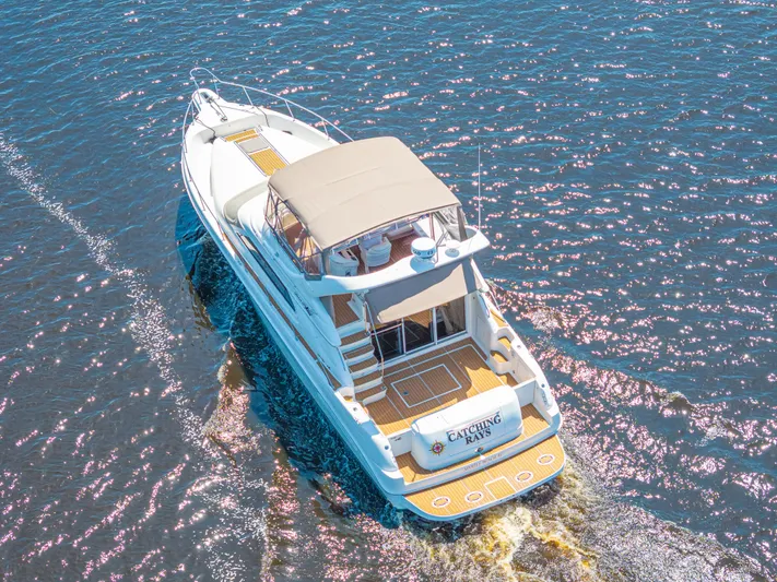  Yacht Photos Pics 1999 Sea Ray 450 Express Bridge yacht cruising on open water, aerial view.