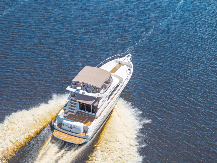  Yacht Photos Pics 1999 Sea Ray 450 Express Bridge cruising on open water, aerial view.