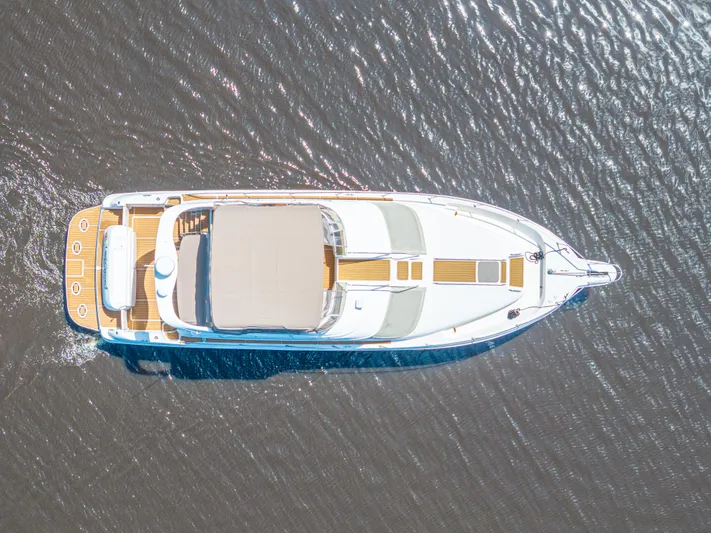  Yacht Photos Pics Aerial view of 1999 Sea Ray 450 Express Bridge yacht on water.