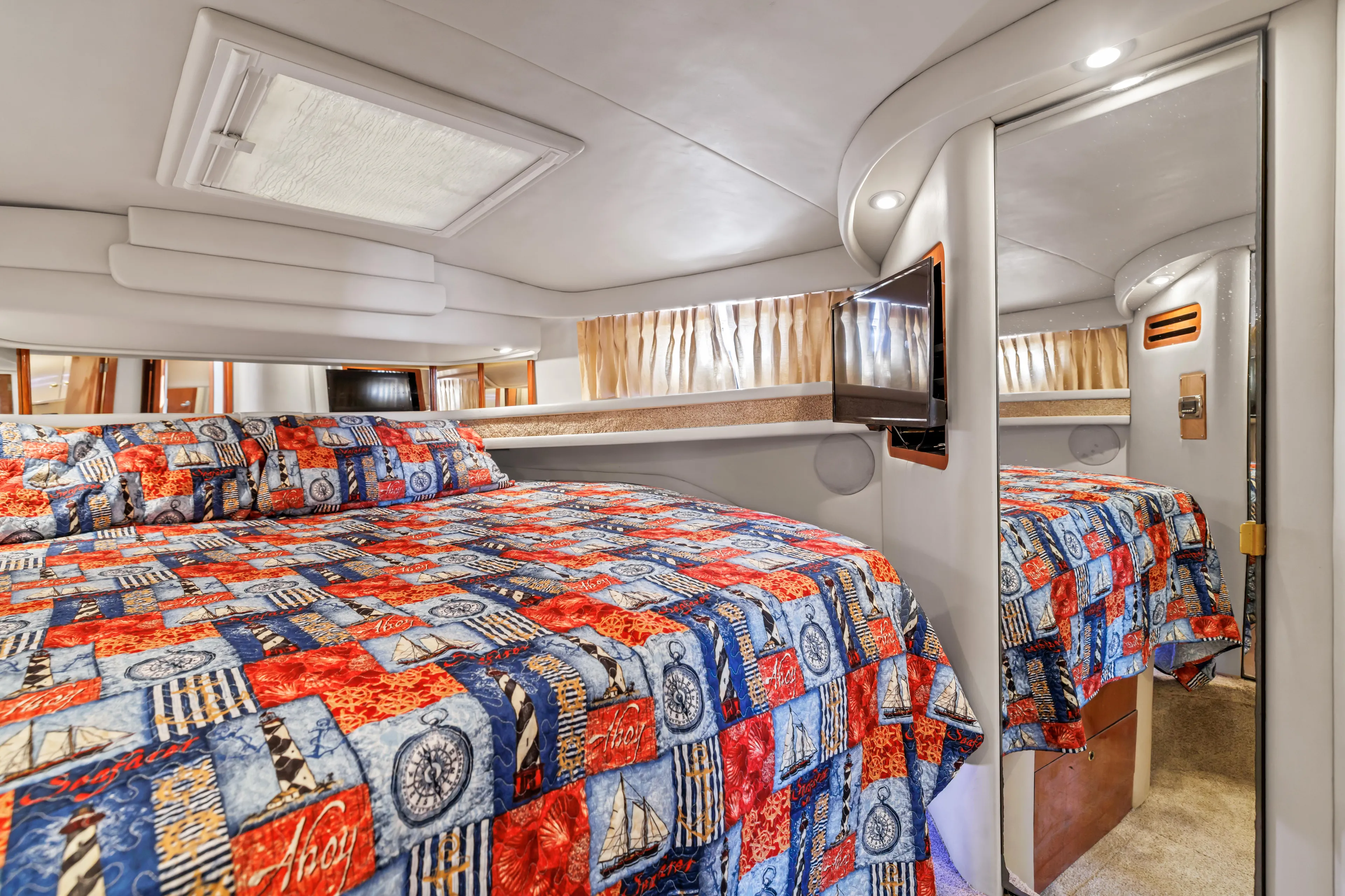  Yacht Photos Pics Luxurious 1999 Sea Ray 450 Express Bridge cabin with vibrant nautical-themed bedding.