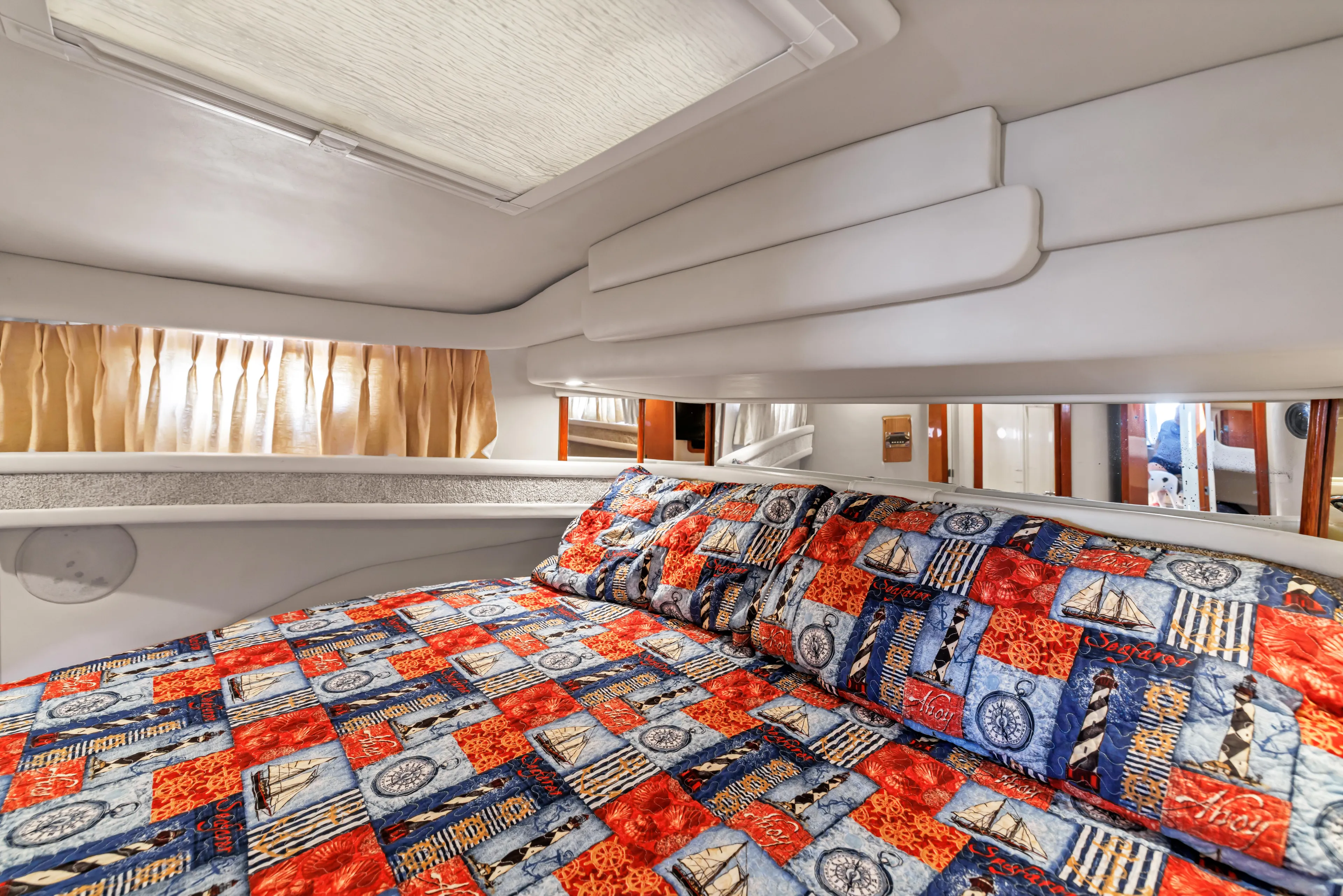  Yacht Photos Pics Cozy cabin interior of 1999 Sea Ray 450 Express Bridge with colorful bedding.
