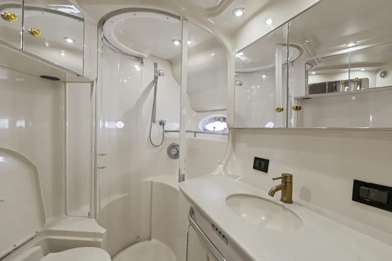  Yacht Photos Pics Luxurious bathroom in 1999 Sea Ray 450 Express Bridge yacht, featuring modern fixtures and elegant design.