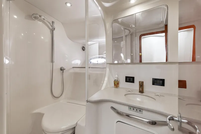  Yacht Photos Pics Luxurious bathroom in 1999 Sea Ray 450 Express Bridge yacht, featuring modern fixtures and elegant design.