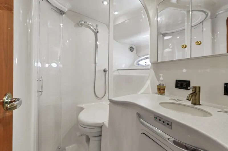  Yacht Photos Pics Luxurious bathroom in 1999 Sea Ray 450 Express Bridge yacht, featuring modern fixtures and elegant design.