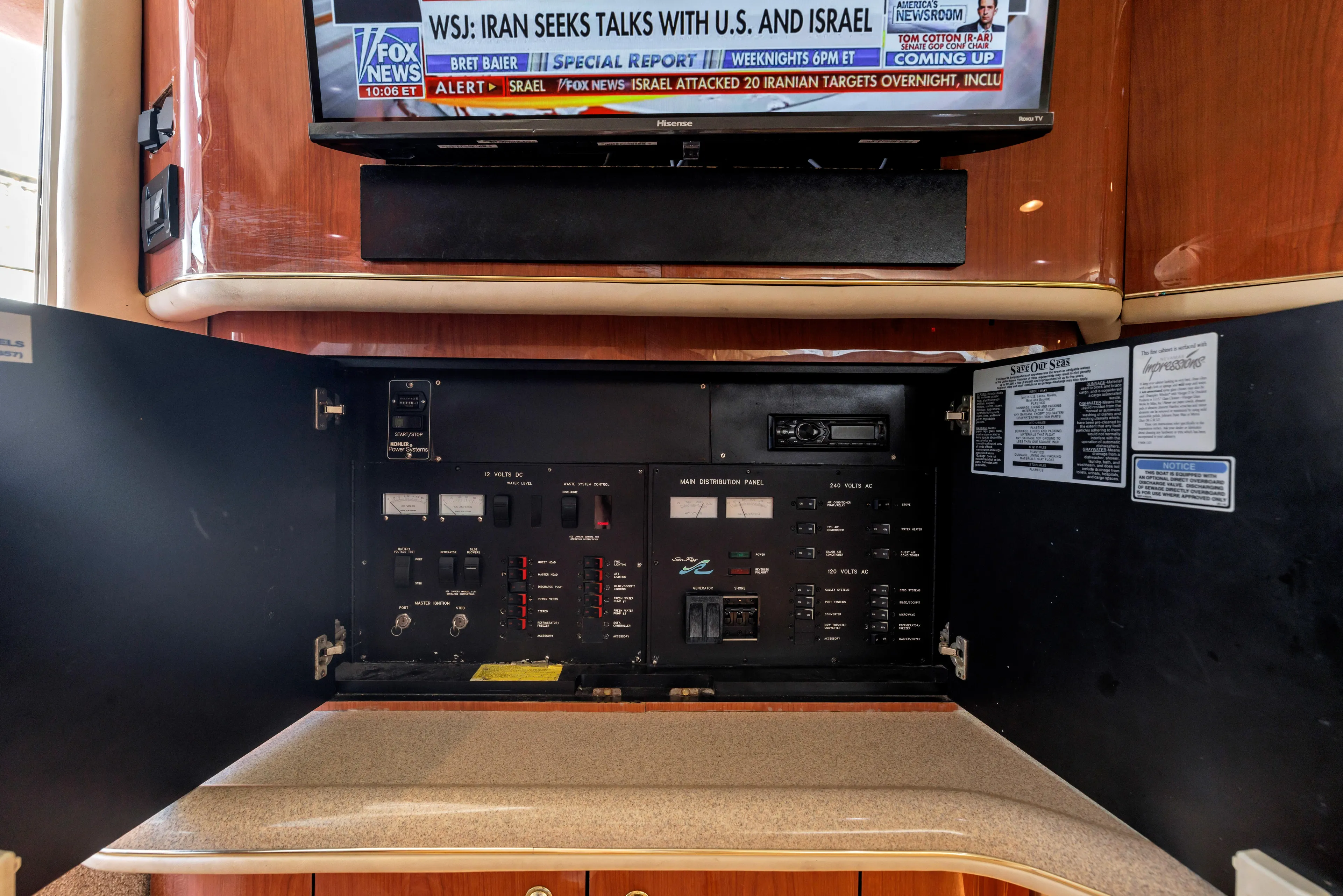  Yacht Photos Pics 1999 Sea Ray 450 Express Bridge electrical panel with TV displaying news broadcast.