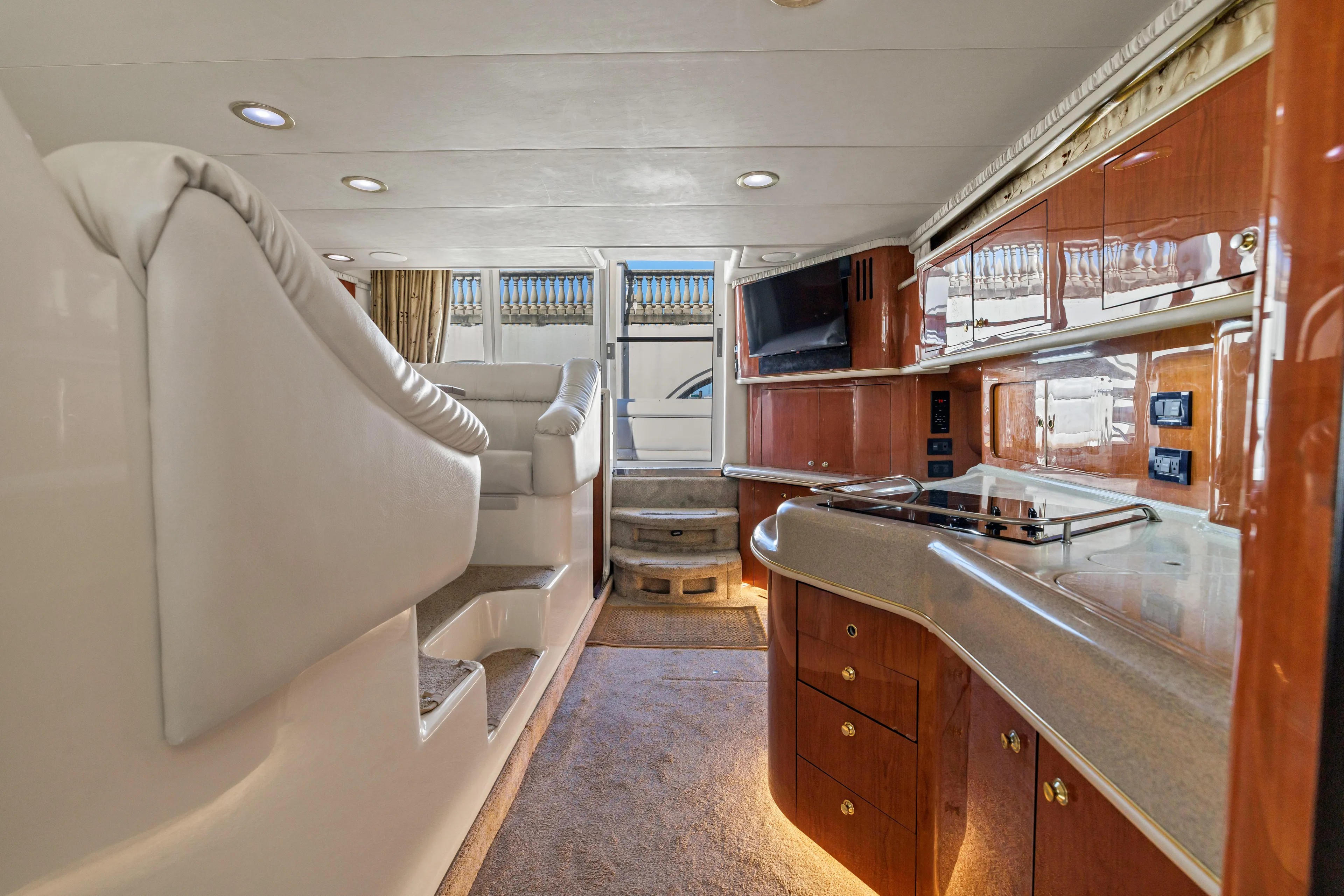  Yacht Photos Pics Luxurious interior of 1999 Sea Ray 450 Express Bridge yacht with modern kitchen and seating area.