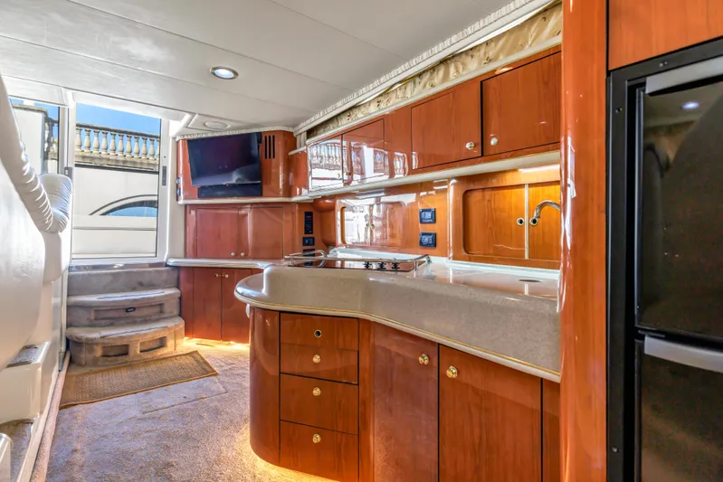  Yacht Photos Pics Luxurious interior of 1999 Sea Ray 450 Express Bridge yacht with modern kitchen amenities.