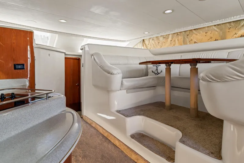  Yacht Photos Pics Luxurious interior of 1999 Sea Ray 450 Express Bridge with elegant seating and dining area.