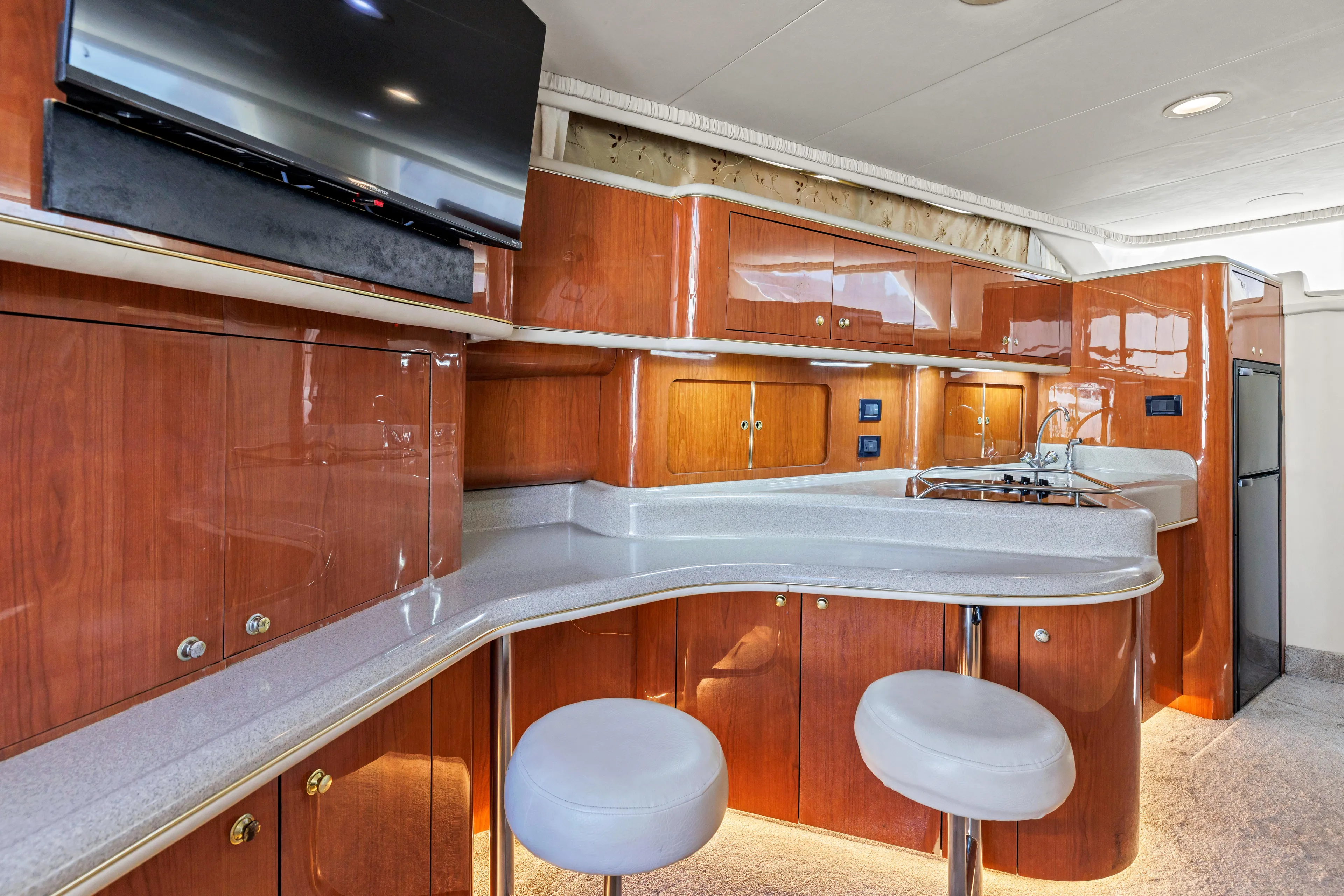  Yacht Photos Pics 1999 Sea Ray 450 Express Bridge interior with modern kitchen and seating area.