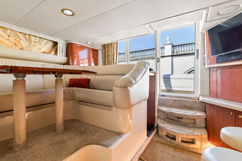  Yacht Photos Pics Luxurious interior of 1999 Sea Ray 450 Express Bridge yacht with plush seating and elegant decor.
