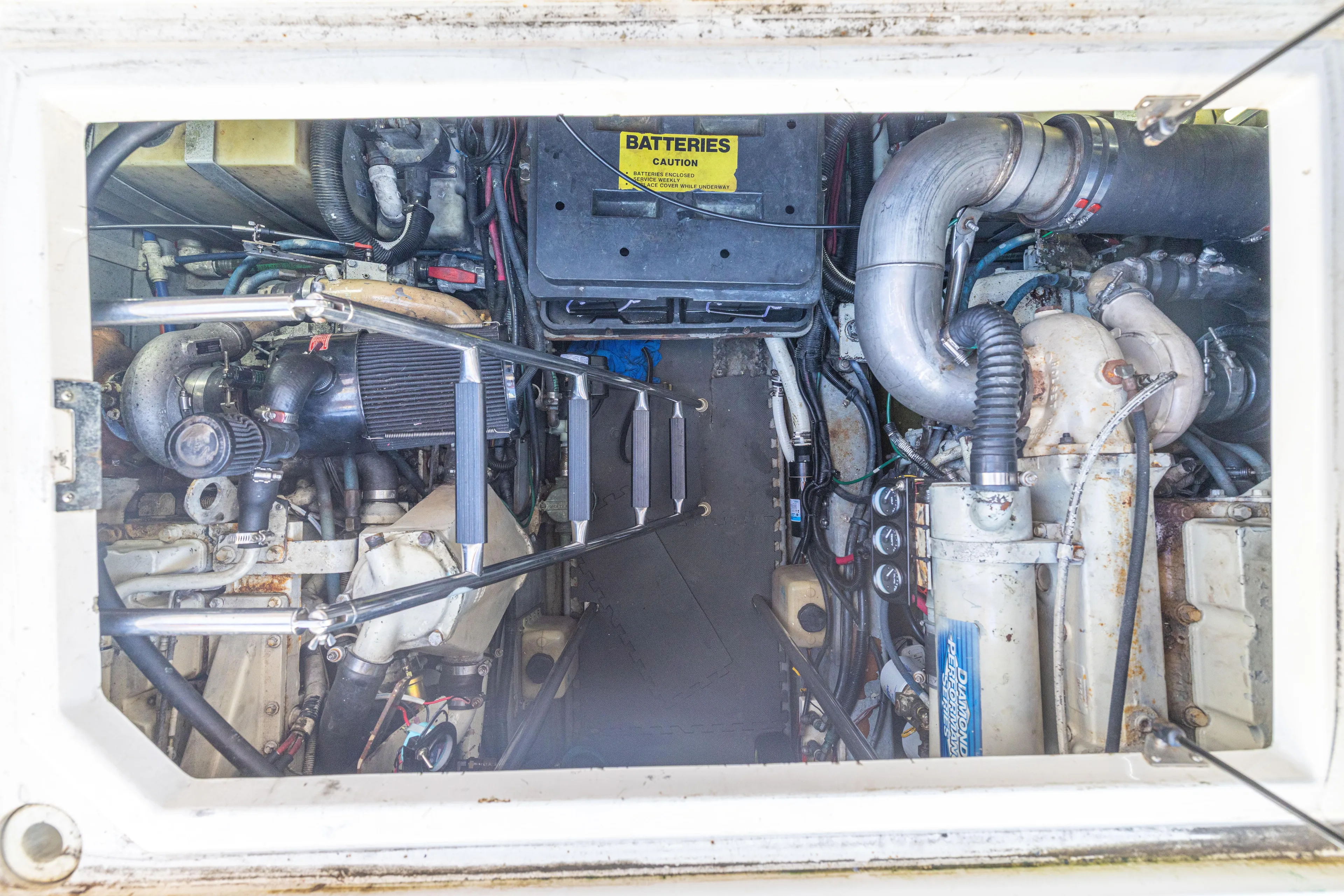  Yacht Photos Pics Engine room of 1999 Sea Ray 450 Express Bridge, showing mechanical components and battery compartment.