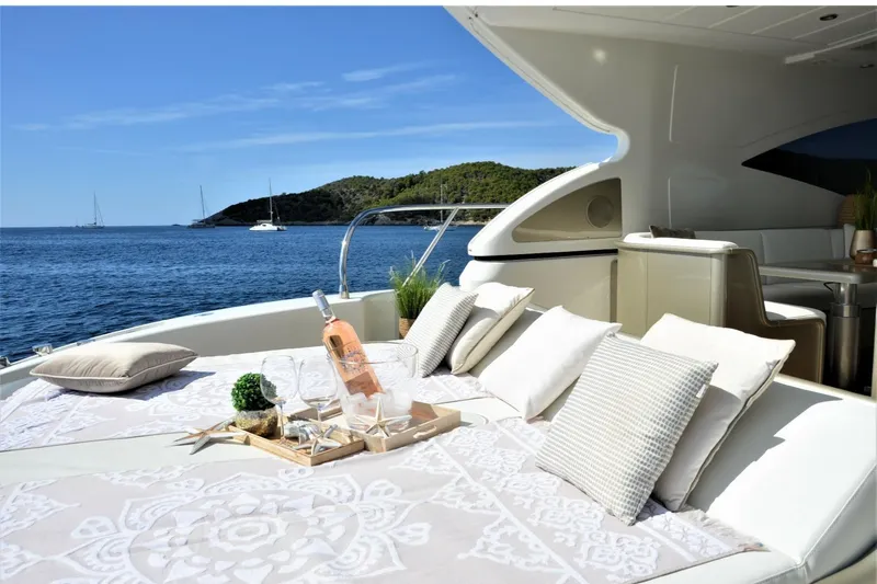  Yacht Photos Pics Luxurious 2003 Mangusta 72 yacht deck with elegant seating, wine, and ocean view.