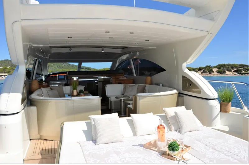  Yacht Photos Pics Luxurious 2003 Mangusta 72 yacht interior with elegant seating and scenic ocean view.