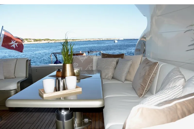  Yacht Photos Pics Luxurious 2003 Mangusta 72 yacht deck with elegant seating and ocean view.