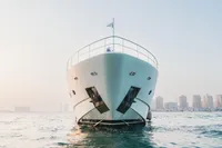 Front view of 2007 Custom Line 112 yacht on water, city skyline in background.